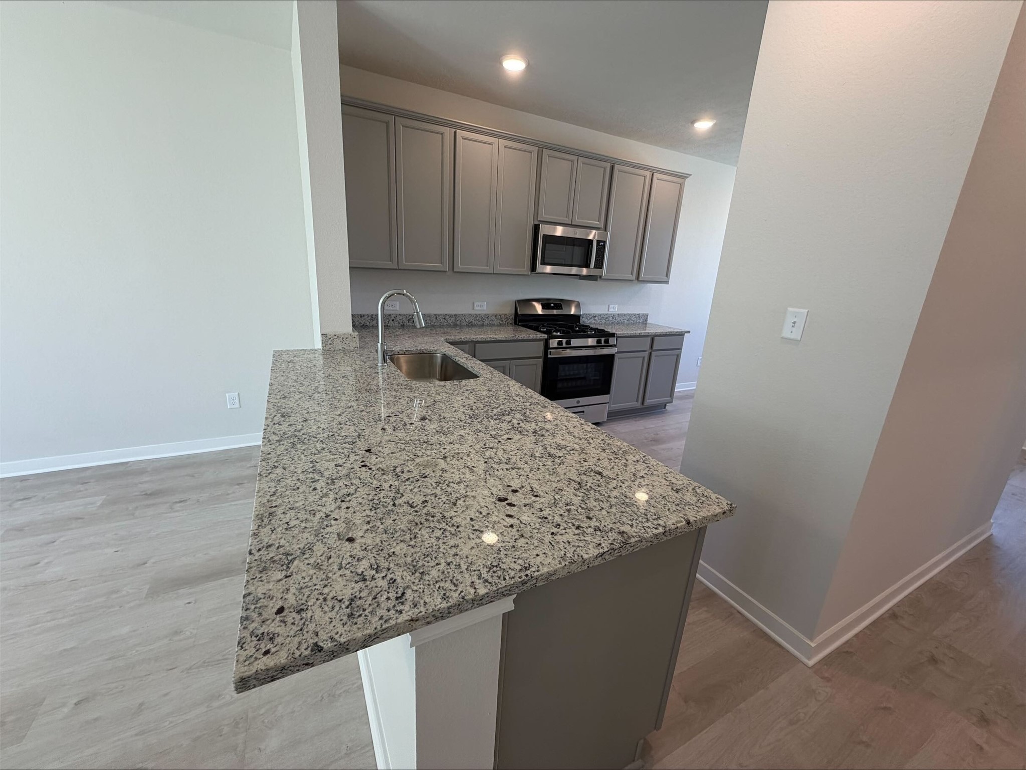237 New Dawn Trail Huntsville, TX 77320 - Photo 7 of 23 a kitchen with stainless steel appliances granite countertop a sink stove and refrigerator