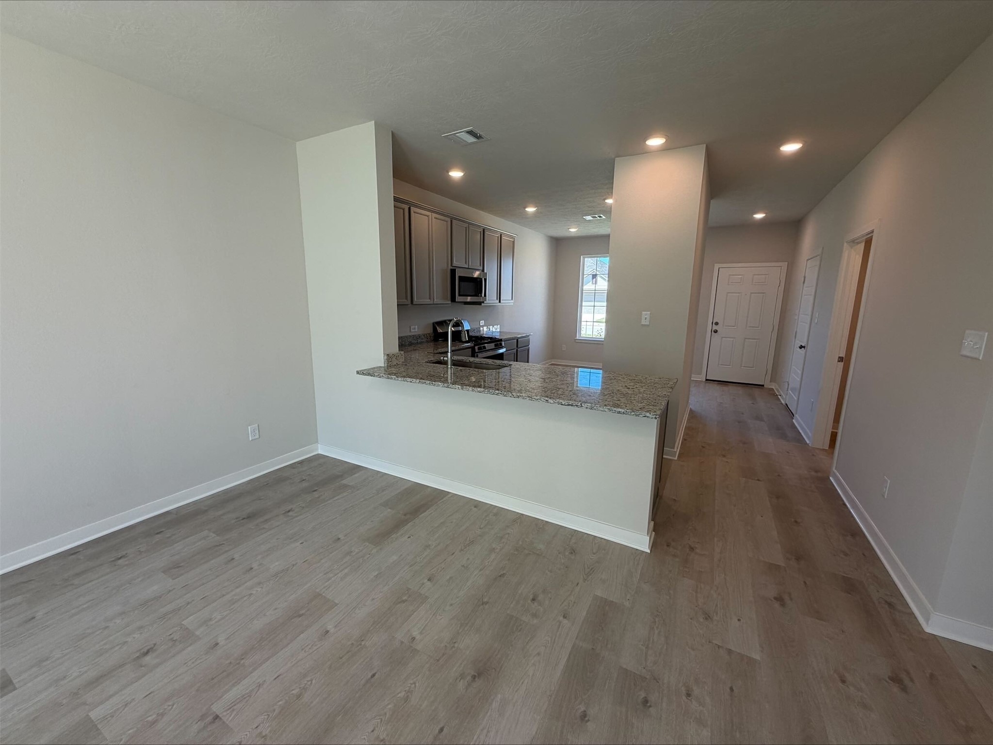 237 New Dawn Trail Huntsville, TX 77320 - Photo 8 of 23 a view of a kitchen with a sink and a refrigerator