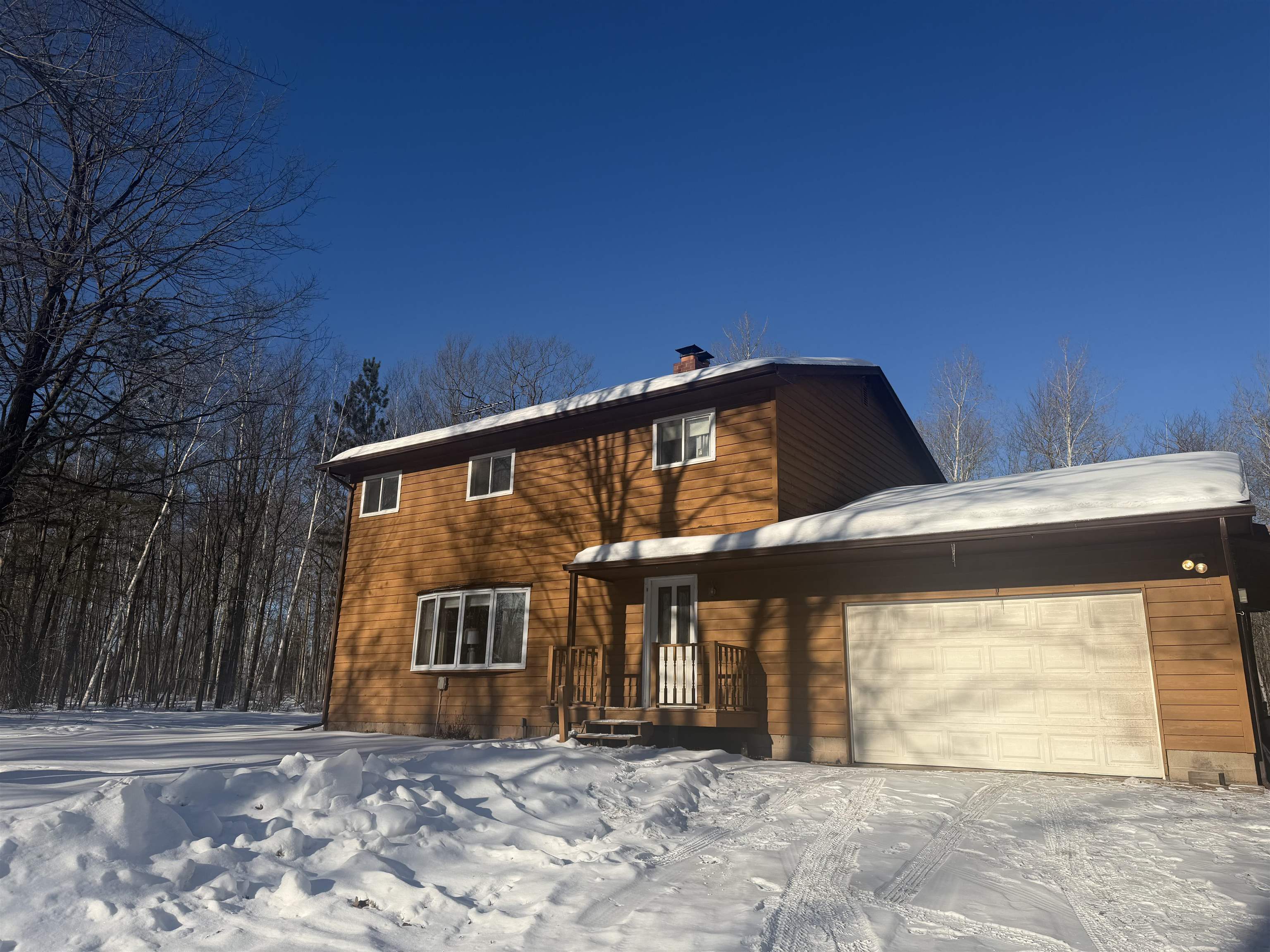 Traditional-style house featuring a garage and a chimney