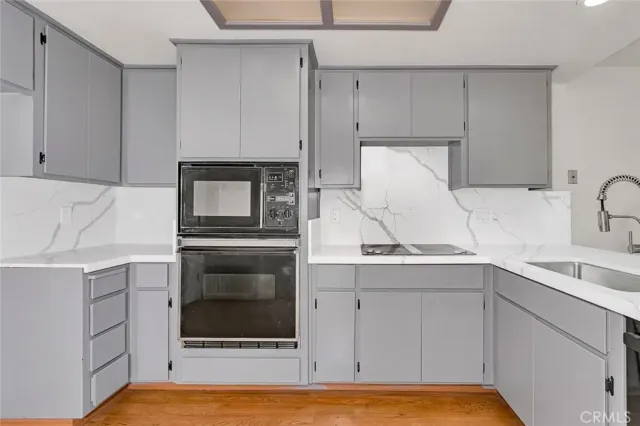 a kitchen with a sink and a stove top oven