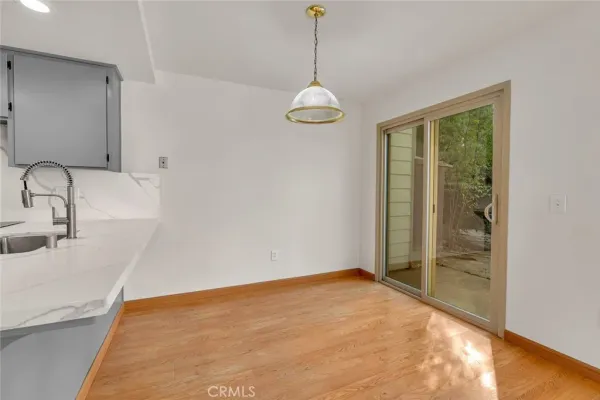 a view of a room with wooden floor and cabinet