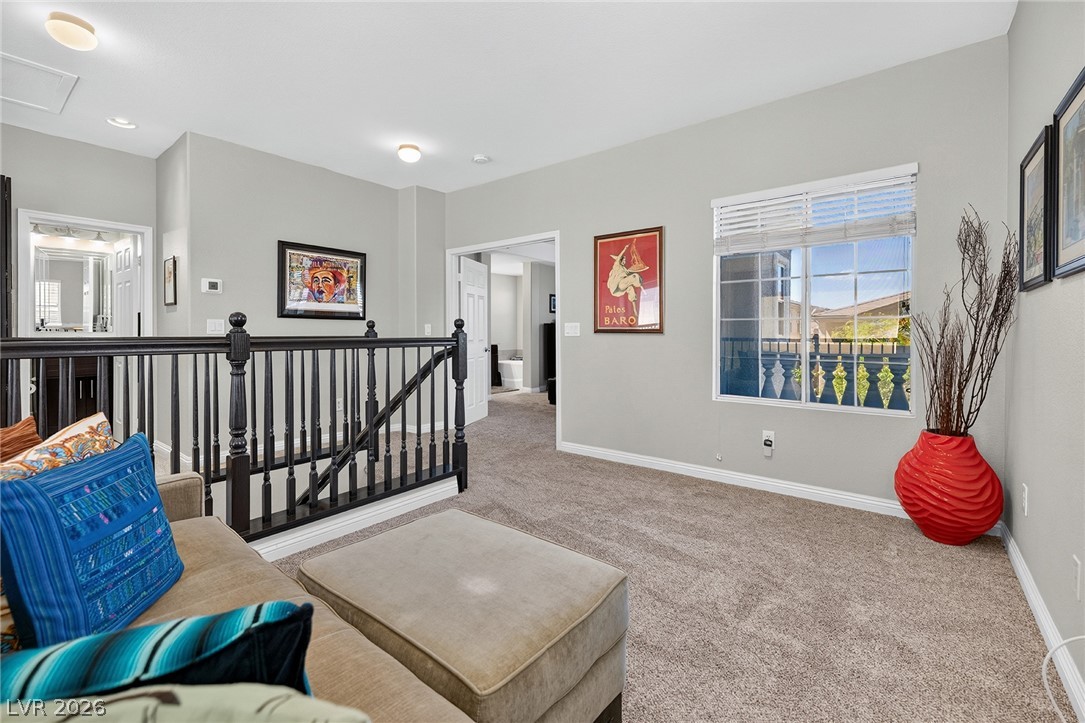226 Priority Point Street Henderson, NV 89012 - Photo 21 of 32 Plush carpeting and a classic balustrade define this versatile upper-level landing space.