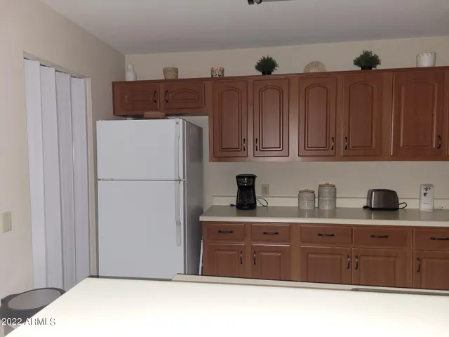 a kitchen with a refrigerator and cabinets
