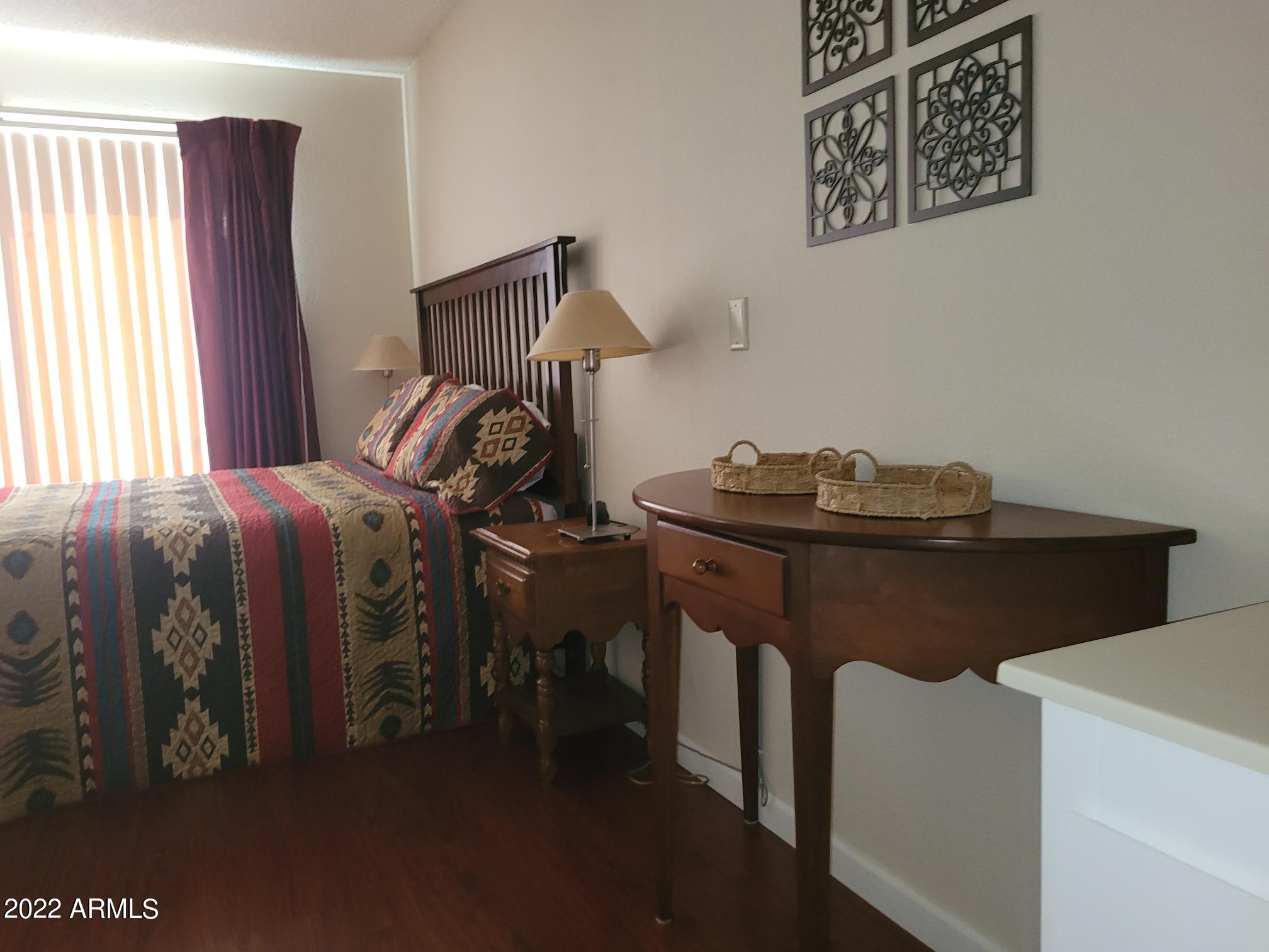 14300 West Bell Road, Unit 513 Surprise, AZ 85374 - Photo 16 of 23 a bedroom with a bed and a window