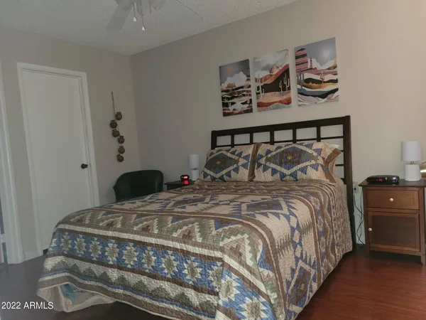 a bedroom with a bed and cabinet