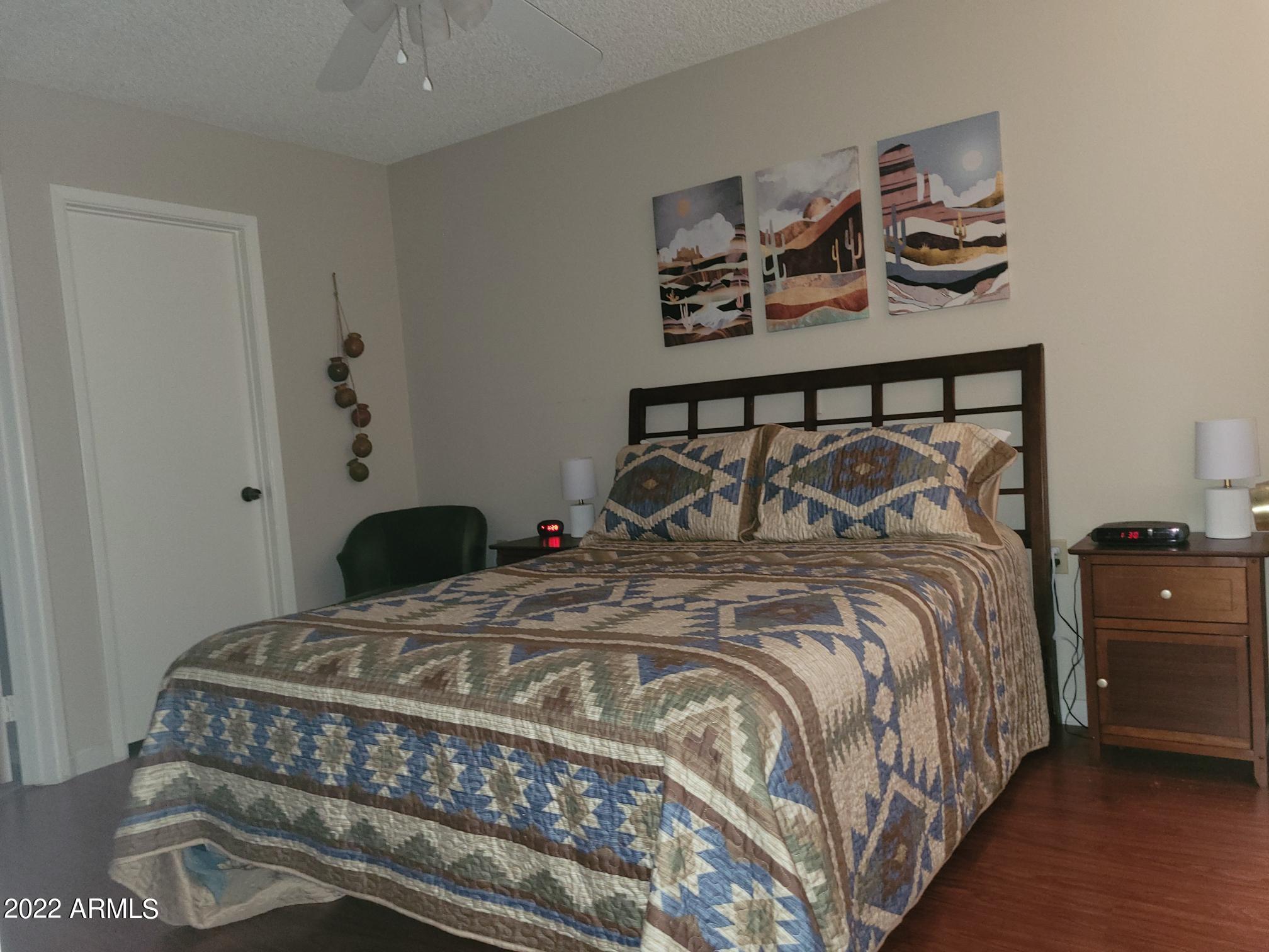 14300 West Bell Road, Unit 513 Surprise, AZ 85374 - Photo 19 of 23 a bedroom with a bed and cabinet