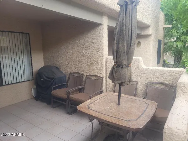 a living room with chairs and a table