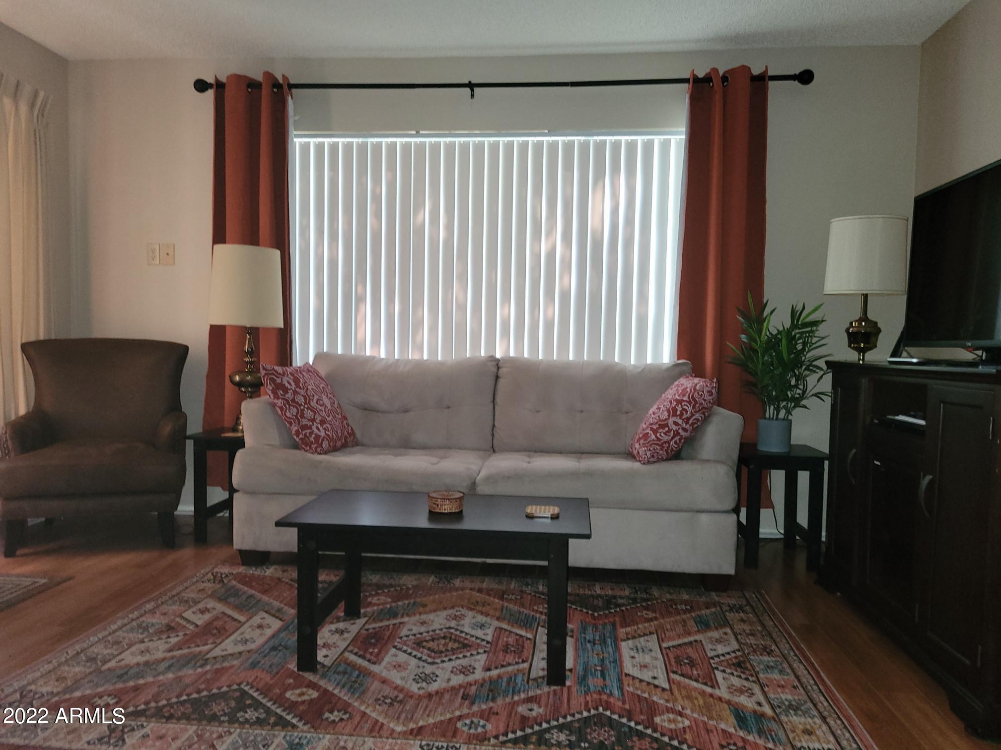 14300 West Bell Road, Unit 513 Surprise, AZ 85374 - Photo 4 of 23 a living room with furniture and a flat screen tv