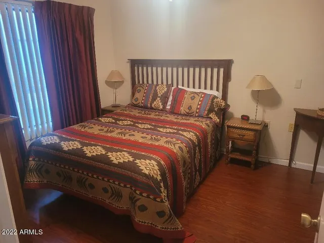 a bedroom with a bed and a mirror