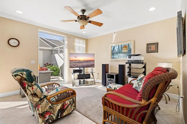 a living room with furniture and a flat screen tv with kitchen view