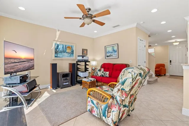 a living room with furniture and chandelier