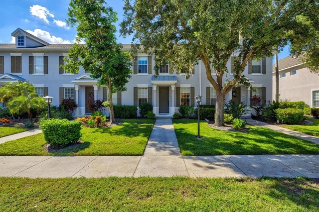 a view of a brick building next to a yard