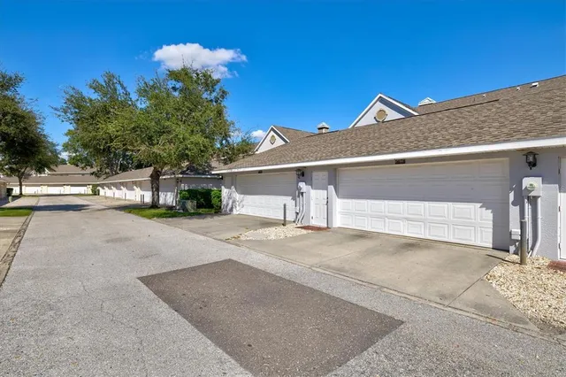 a view of a patio with a table and chairs under an umbrella