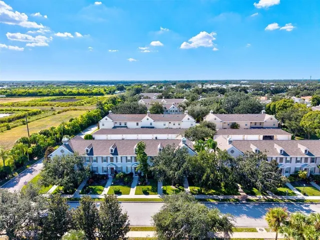 an aerial view of a house swimming pool and lake view