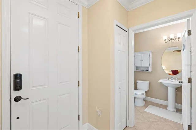 a bathroom with a toilet a sink and mirror