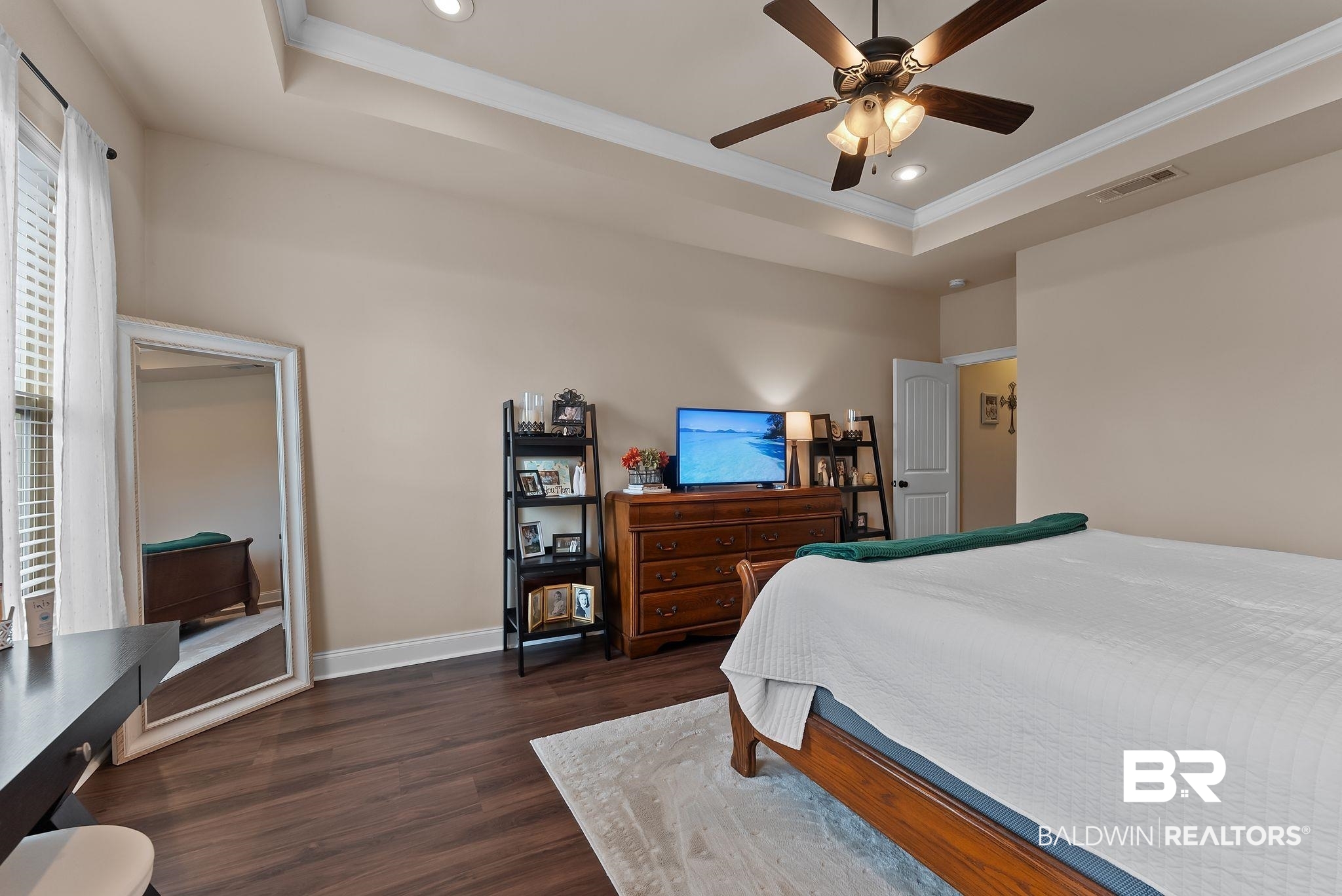 7015 Rocky Rd Loop Gulf Shores, AL 36542 - Photo 28 of 41 Bedroom featuring ornamental molding, dark wood-type flooring, recessed lighting, a ceiling fan, and a raised ceiling