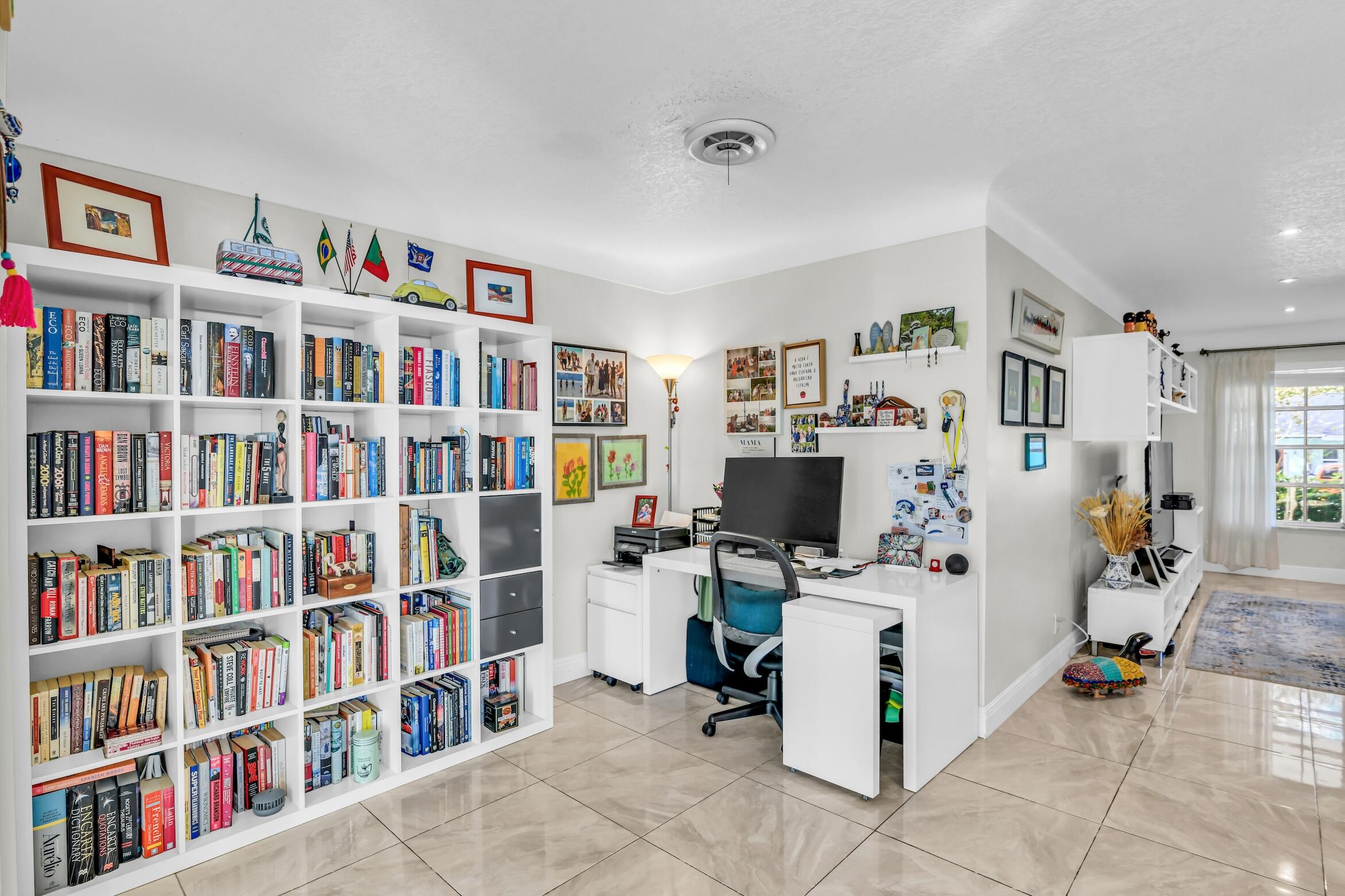 1290 Southwest 8th Street Boca Raton, FL 33486 - Photo 18 of 36 a view of a workspace with bookshelf