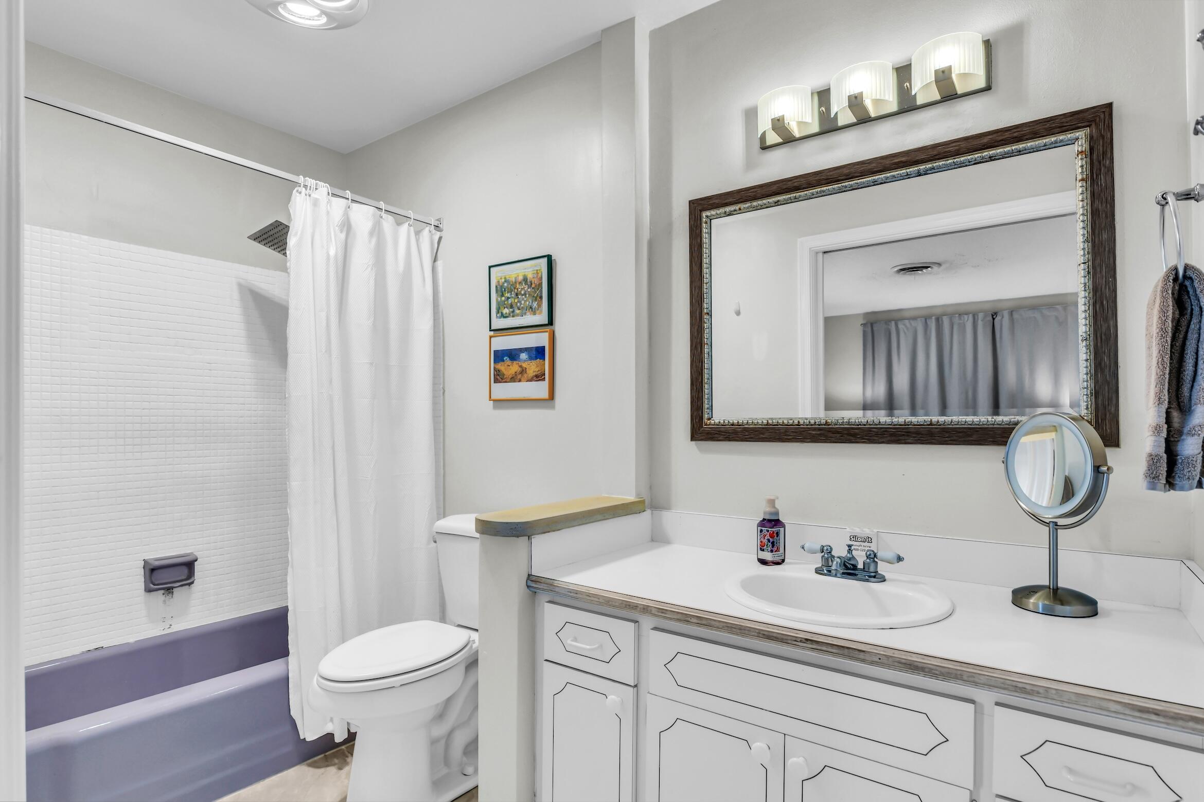 1290 Southwest 8th Street Boca Raton, FL 33486 - Photo 22 of 36 a bathroom with a toilet a sink and mirror