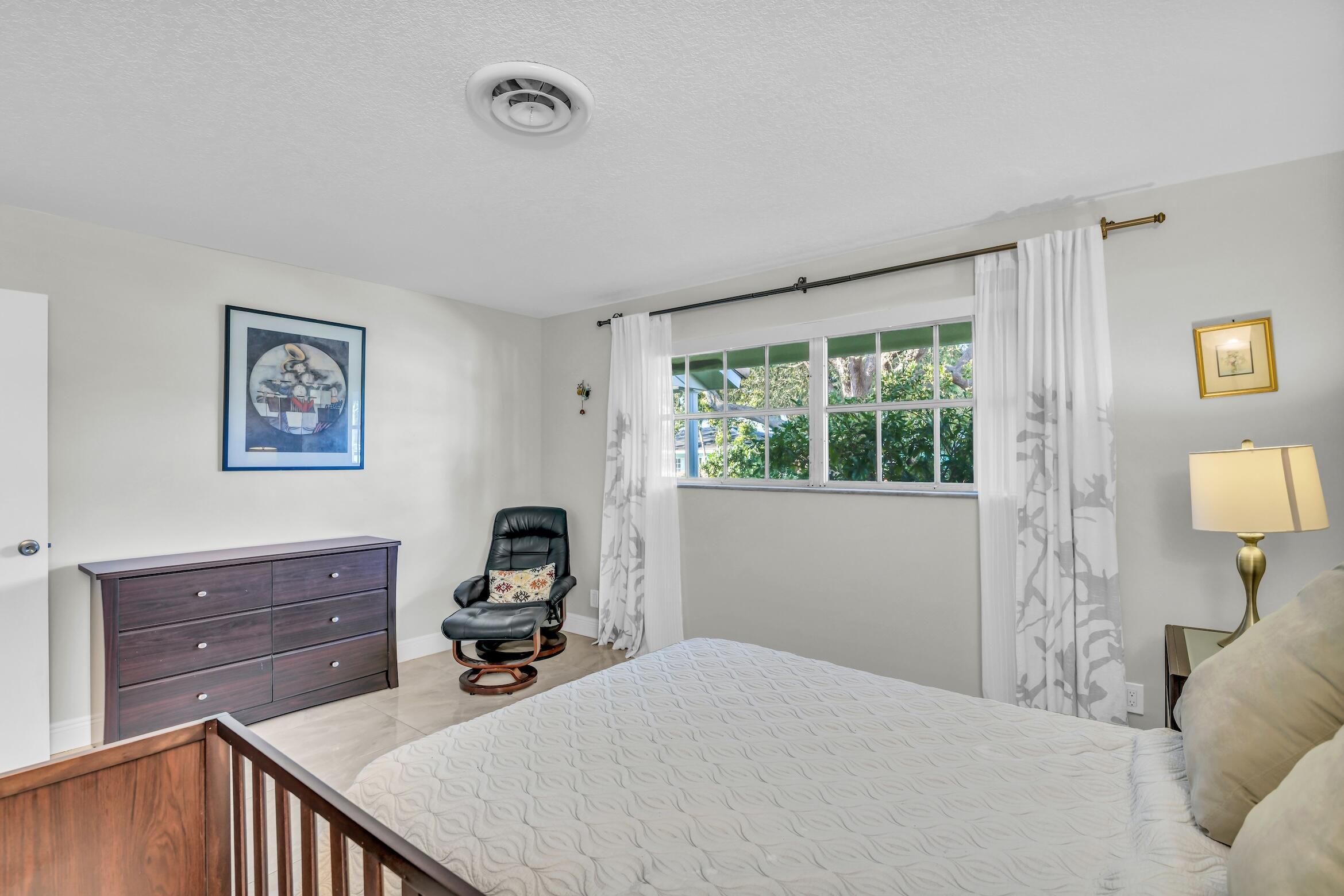 1290 Southwest 8th Street Boca Raton, FL 33486 - Photo 25 of 36 a room that has a bed and a window