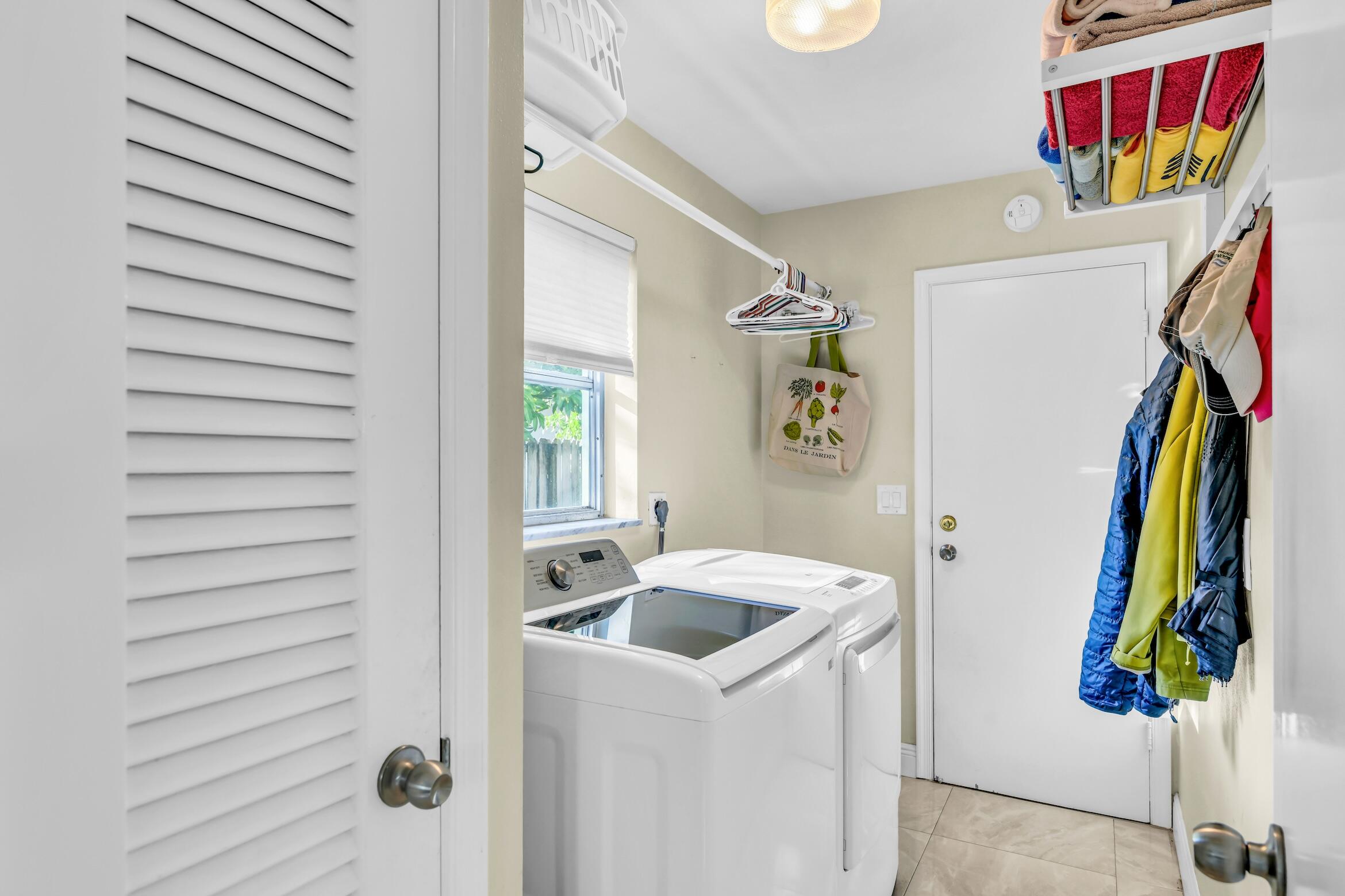 1290 Southwest 8th Street Boca Raton, FL 33486 - Photo 28 of 36 a view of walk in closet with clothes and shoes