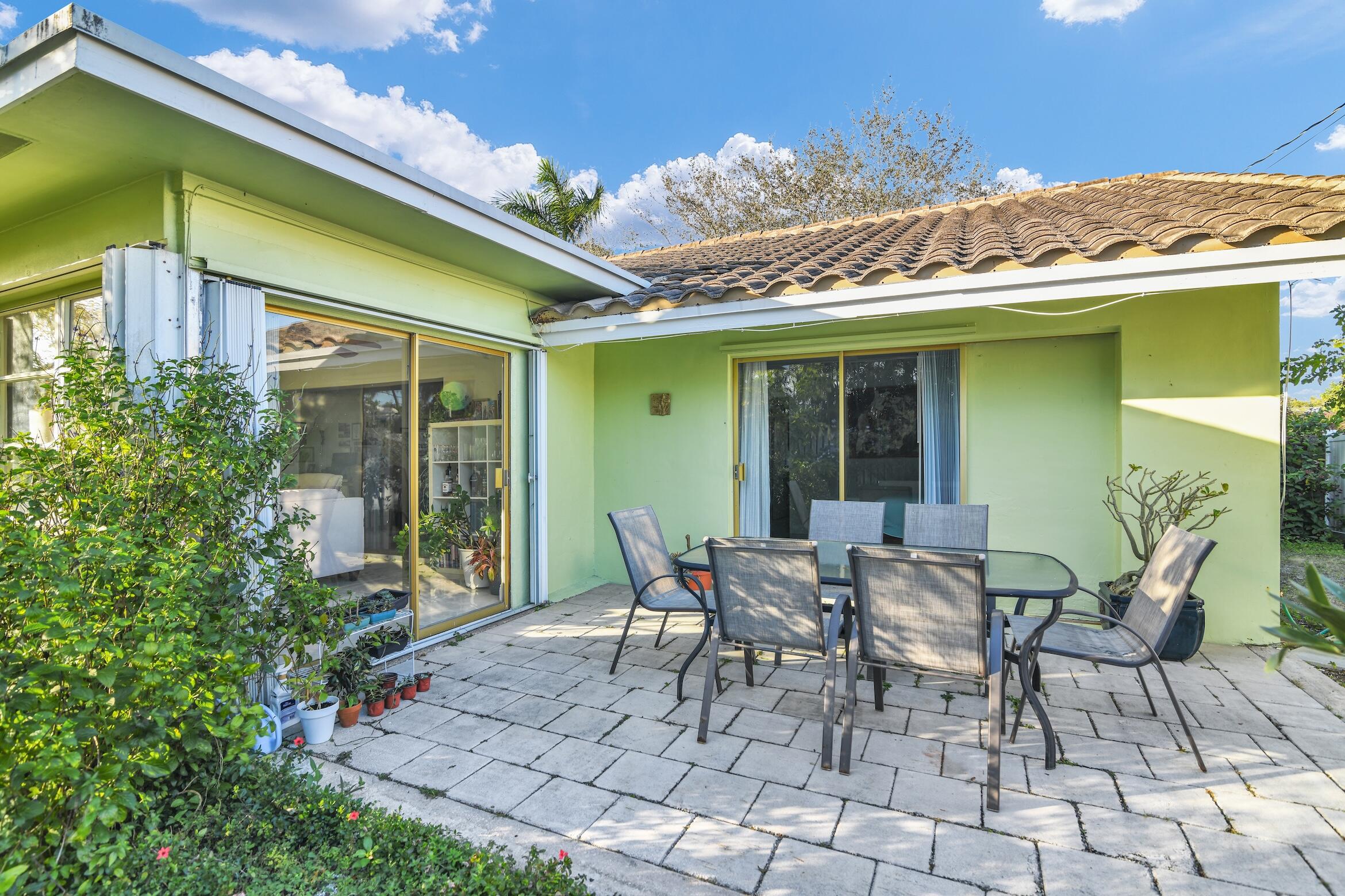1290 Southwest 8th Street Boca Raton, FL 33486 - Photo 31 of 36 a view of a patio with table and chairs and potted plants
