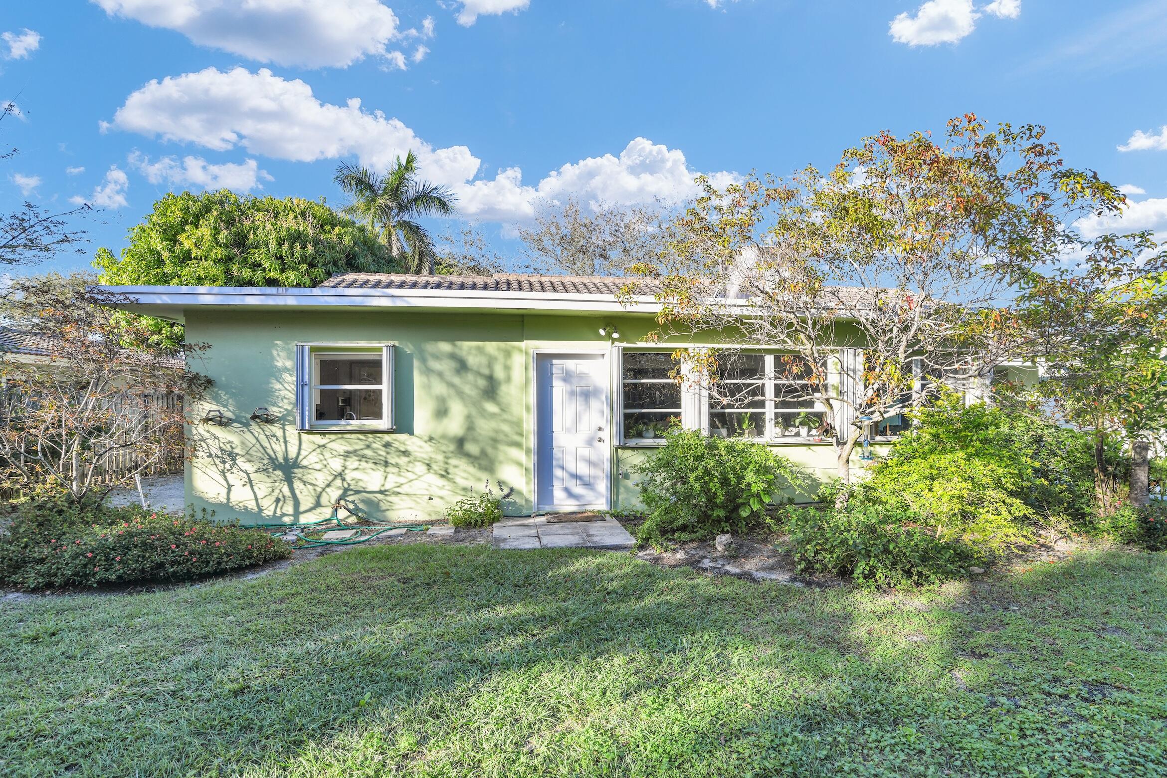 1290 Southwest 8th Street Boca Raton, FL 33486 - Photo 32 of 36 a view of a house with a yard