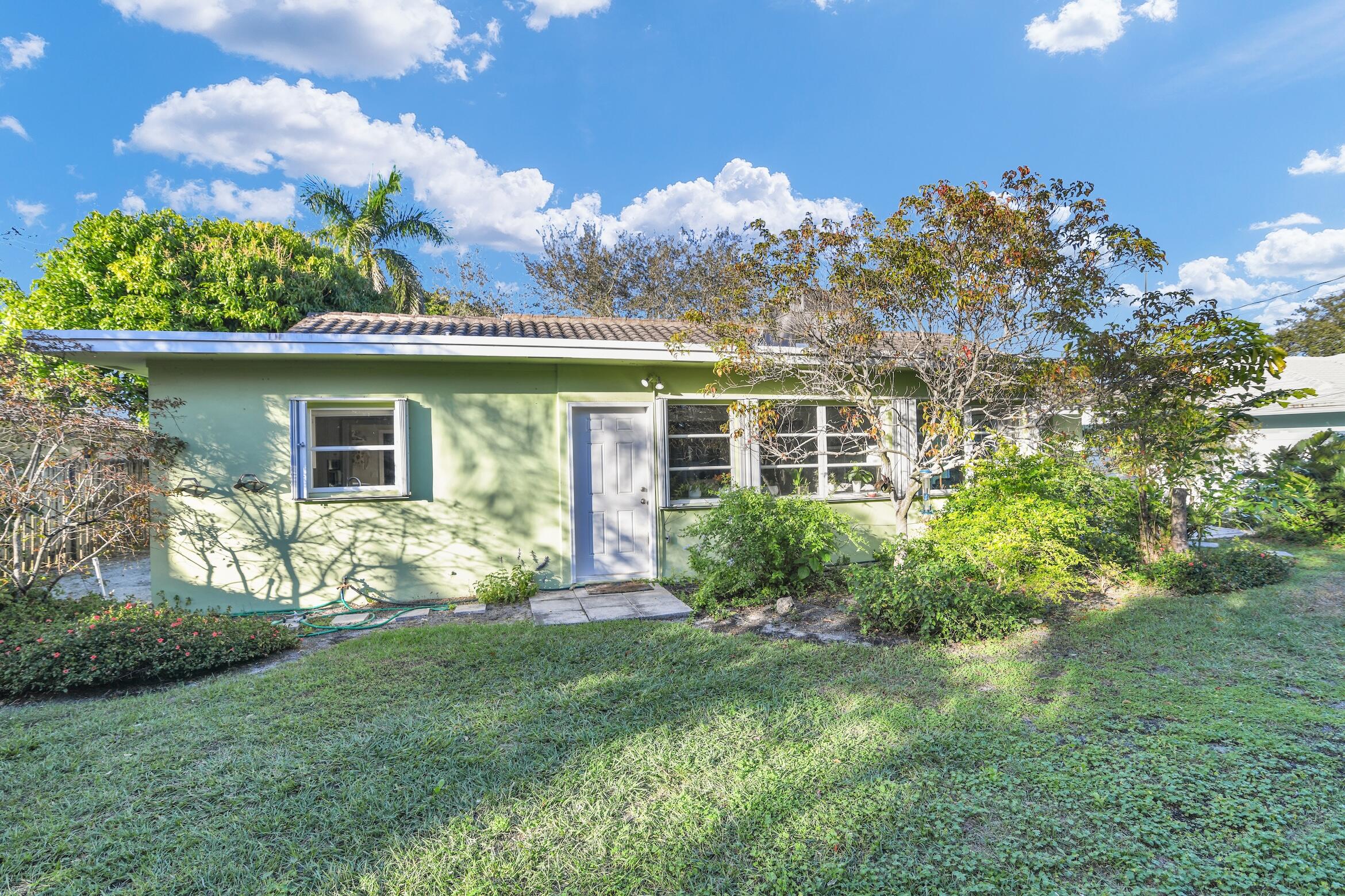 1290 Southwest 8th Street Boca Raton, FL 33486 - Photo 34 of 36 a view of a house with a yard