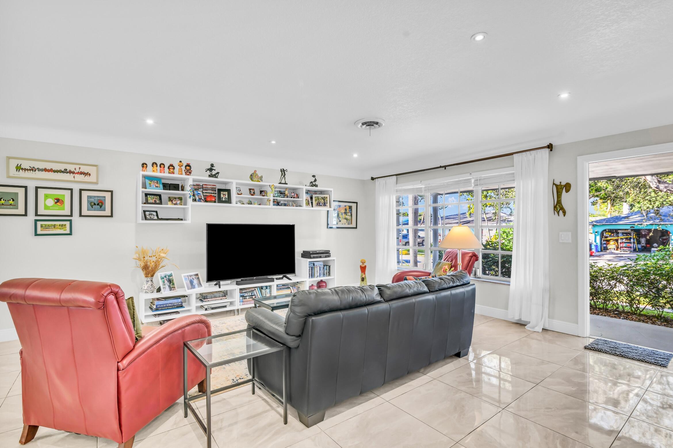 1290 Southwest 8th Street Boca Raton, FL 33486 - Photo 4 of 36 a living room with furniture and a flat screen tv