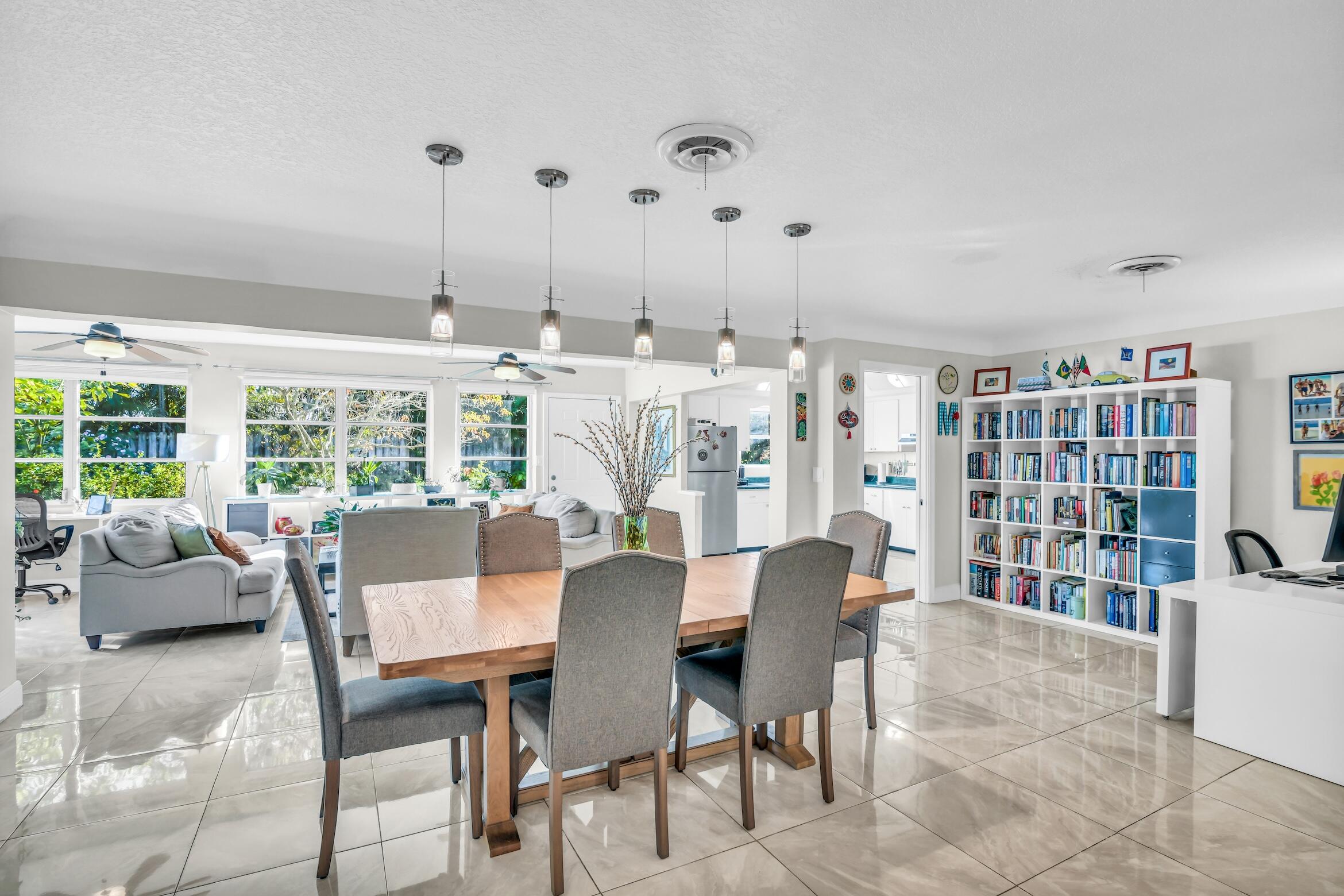 1290 Southwest 8th Street Boca Raton, FL 33486 - Photo 10 of 36 a dining room with furniture windows and a chandelier