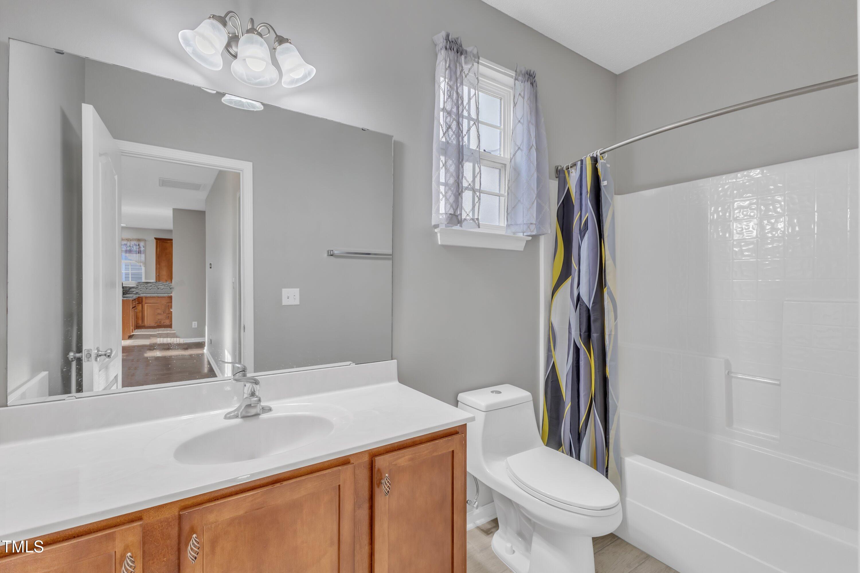 3408 Dutchman Road Raleigh, NC 27610 - Photo 17 of 54 a bathroom with a granite countertop sink toilet and shower