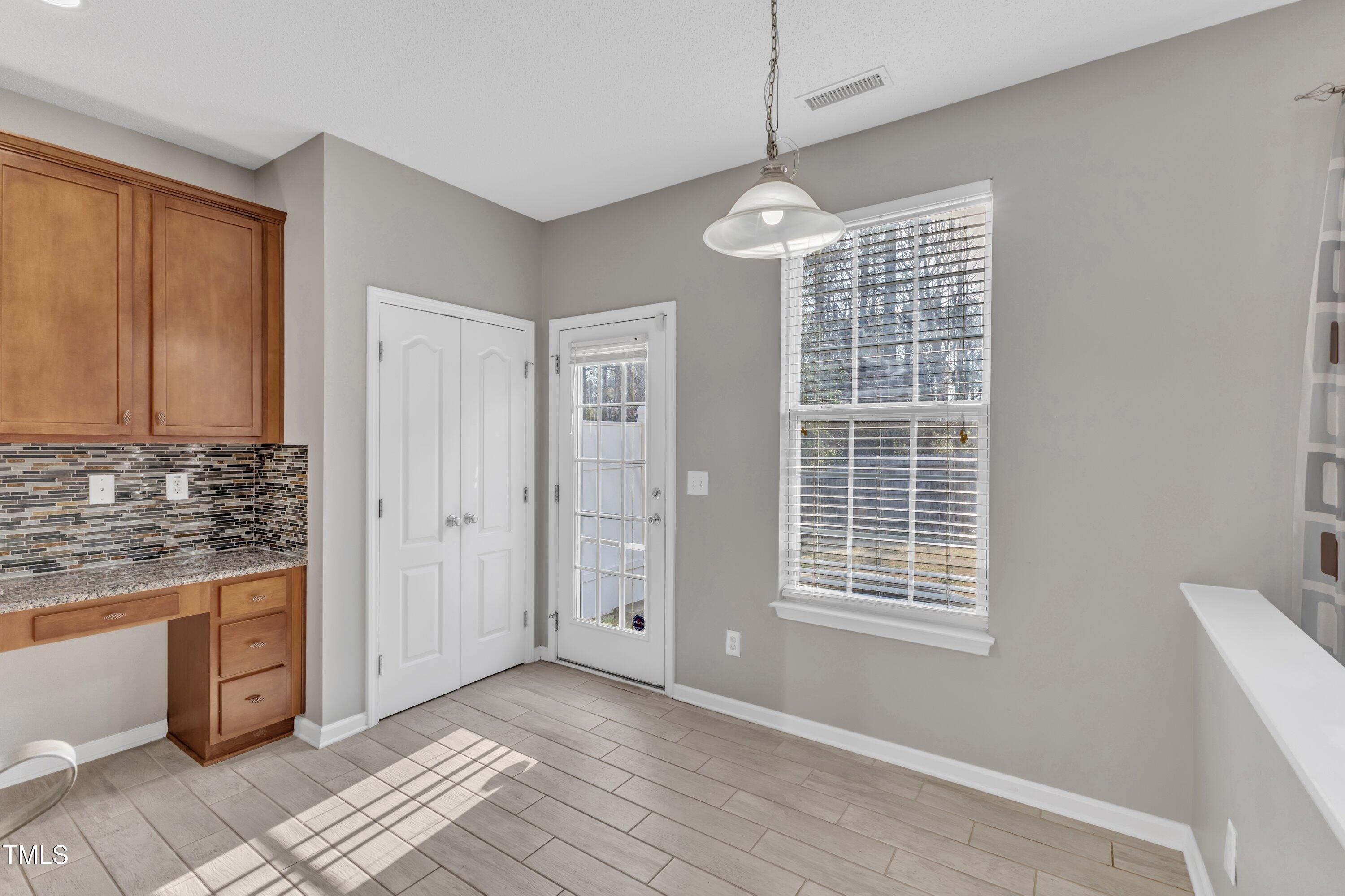 3408 Dutchman Road Raleigh, NC 27610 - Photo 29 of 54 a view of kitchen with granite countertop cabinets and window