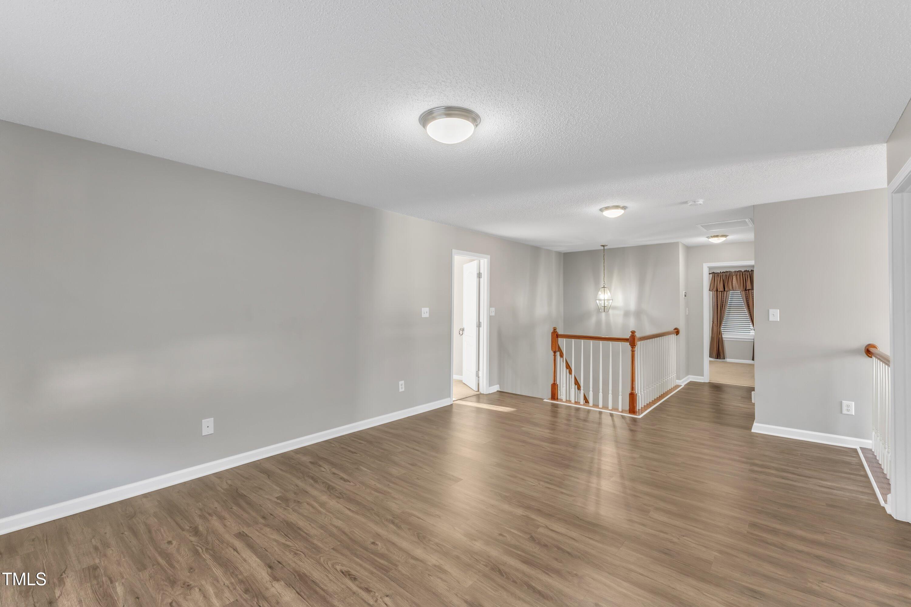 3408 Dutchman Road Raleigh, NC 27610 - Photo 32 of 54 a view of empty room with wooden floor