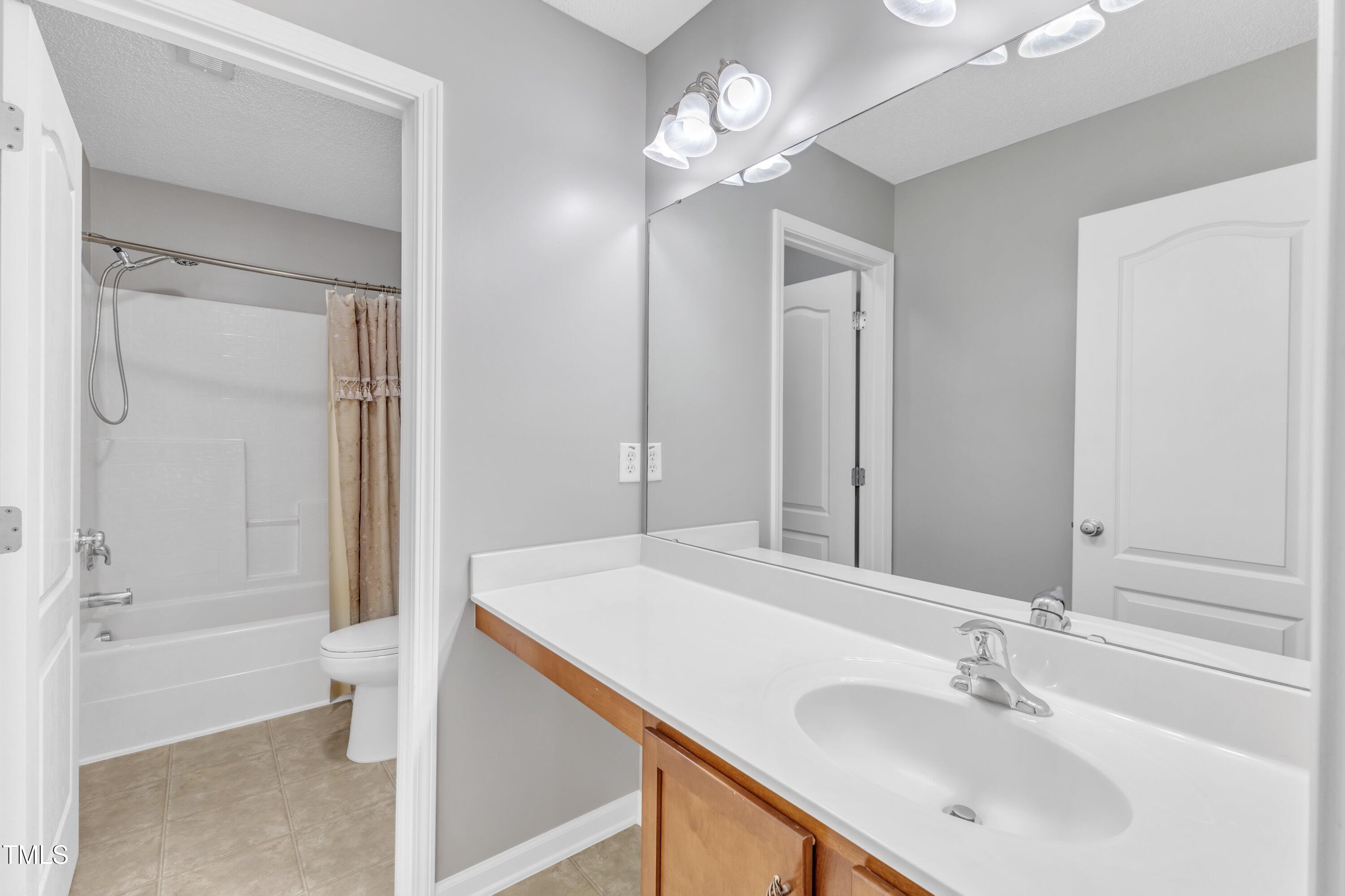 3408 Dutchman Road Raleigh, NC 27610 - Photo 44 of 54 a bathroom with a sink a toilet and shower