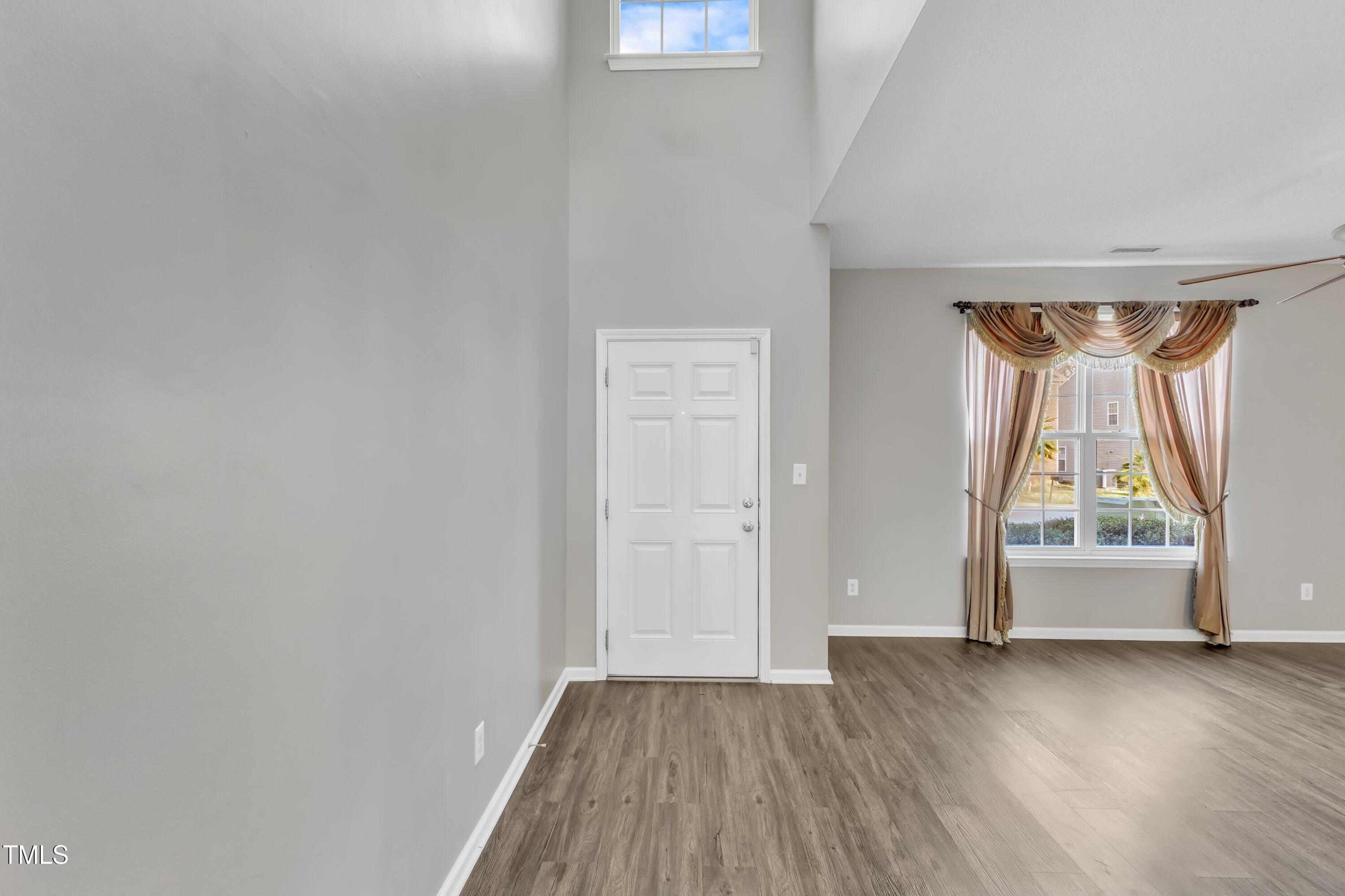 3408 Dutchman Road Raleigh, NC 27610 - Photo 7 of 54 a view of empty room with wooden floor and fan