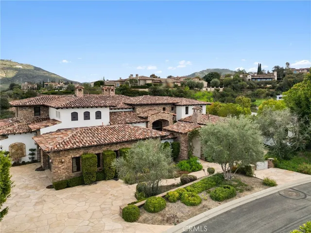 an aerial view of a house with garden space and street view