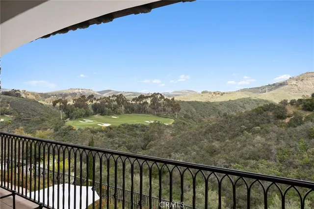 a balcony with an outdoor space and mountain view