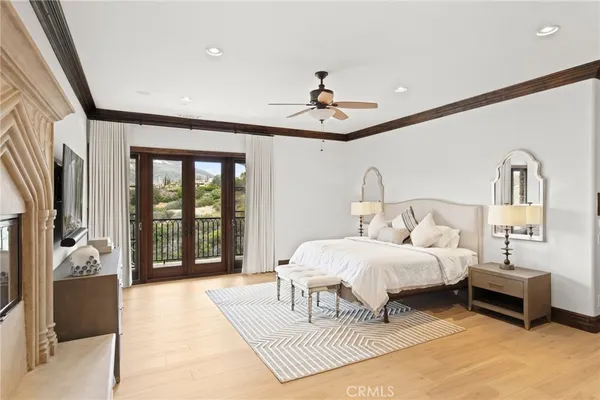 a bedroom with a large bed and a chandelier