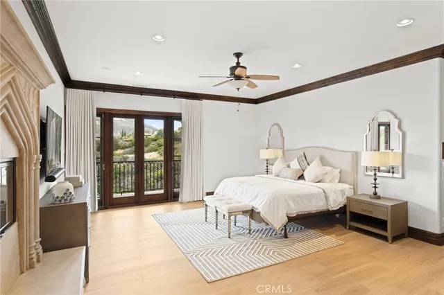 a bedroom with a large bed and a chandelier