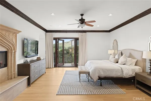 a spacious bedroom with a large bed and a chandelier