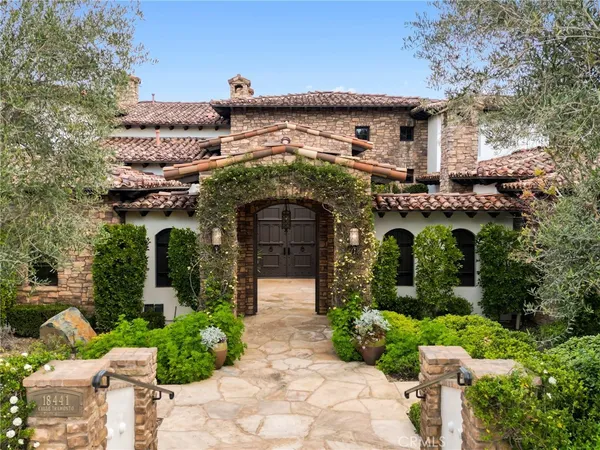a front view of a house with plants and entryway