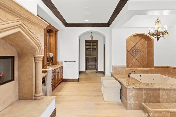 a bathroom with a tub sink and mirror