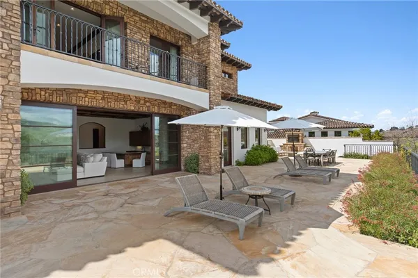 a view of a house with backyard porch and sitting area