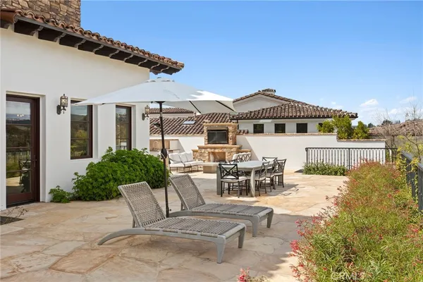 a backyard of a house with fire pit and outdoor seating
