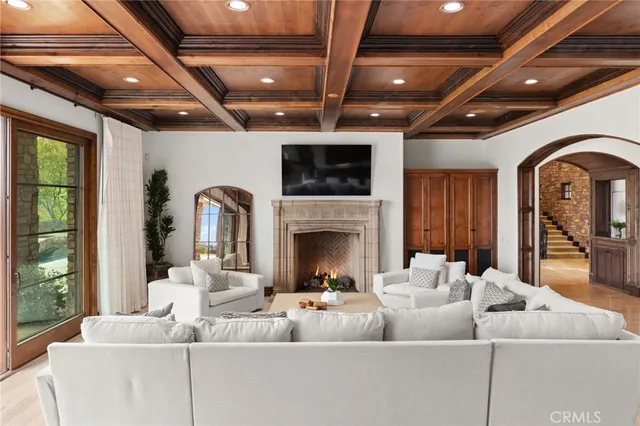 a living room with furniture fireplace and flat screen tv