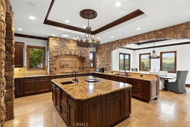 a kitchen with granite countertop center island and stainless steel appliances