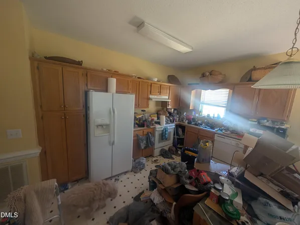 a kitchen with a refrigerator and a stove
