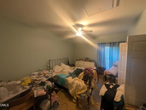 a bed sitting in a bedroom next to a lamp