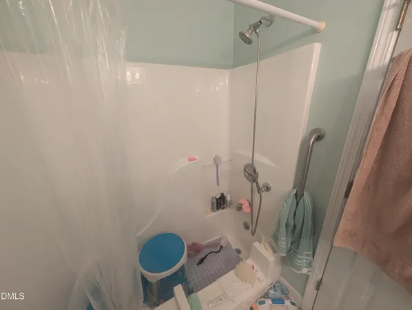 a bathroom with a granite countertop toilet and a shower