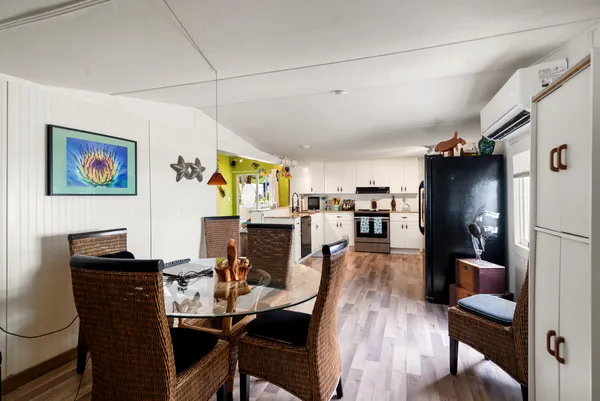 a view of a dining room with furniture and wooden floor