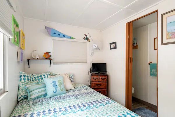 a bedroom with a bed and a television